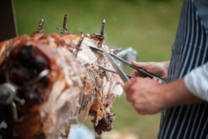 hog roast being carved for serving