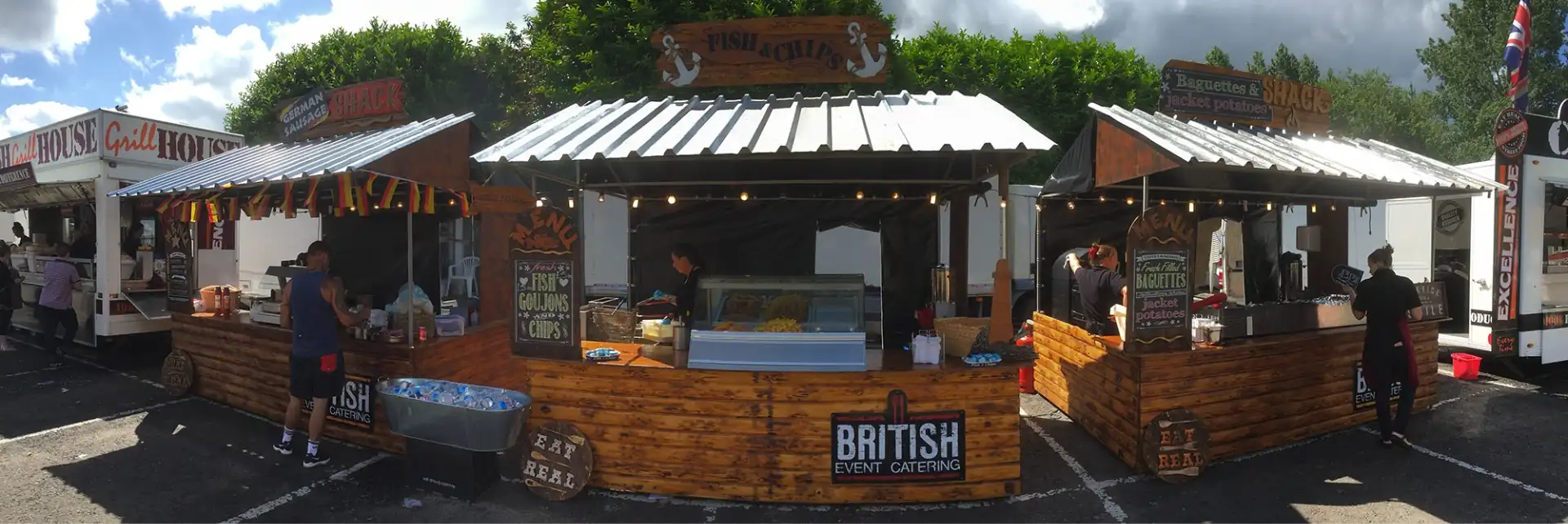 British Event Catering shacks set up for event. Green trees in the background