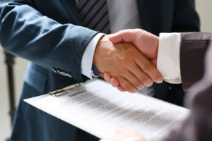 two people handshaking over a contract